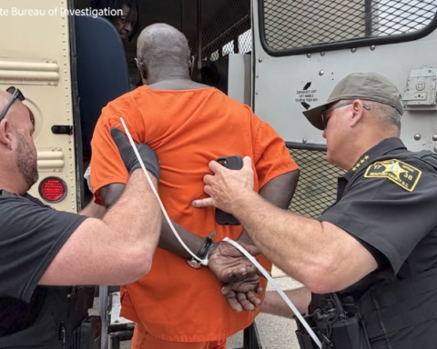Inmate being taken into custody.